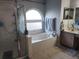 Bathroom with soaking tub, shower, and dual sinks at 12212 Holly Jane Ct, Orlando, FL 32824