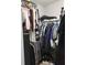A walk-in closet full of hanging clothes, shelves with folded items, and shoes on the floor at 12212 Holly Jane Ct, Orlando, FL 32824