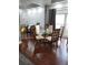 Open-concept dining area flowing into the living space, featuring a round glass table and wood floors at 12212 Holly Jane Ct, Orlando, FL 32824