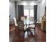 Bright dining room with round glass table and hardwood floors at 12212 Holly Jane Ct, Orlando, FL 32824