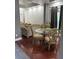 Elegant dining room with a glass table, hardwood floors, and neutral decor at 12212 Holly Jane Ct, Orlando, FL 32824