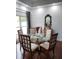 Bright dining area with a glass-top table, seating for four, and stylish decor accents at 12212 Holly Jane Ct, Orlando, FL 32824
