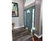 Bright entryway with gray walls, wood-look flooring, and a teal door at 12212 Holly Jane Ct, Orlando, FL 32824