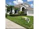 Charming two-story home with landscaped yard, lush lawn, and an attached two car garage in a suburban neighborhood at 12212 Holly Jane Ct, Orlando, FL 32824