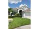 Charming two-story home with landscaped yard, lush lawn, and an attached two car garage in a suburban neighborhood at 12212 Holly Jane Ct, Orlando, FL 32824