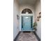 Charming entrance with a blue front door, transom window, and brick walkway at 12212 Holly Jane Ct, Orlando, FL 32824