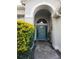 Beautiful front entrance with a blue door, transom window, and manicured bushes at 12212 Holly Jane Ct, Orlando, FL 32824