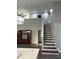 Spacious interior view showcasing the staircase, living area, and modern lighting fixtures at 12212 Holly Jane Ct, Orlando, FL 32824