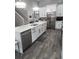 Modern kitchen with white cabinets, stainless steel appliances, and quartz countertops at 12212 Holly Jane Ct, Orlando, FL 32824