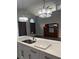 Open kitchen featuring modern light fixtures and stainless steel sink at 12212 Holly Jane Ct, Orlando, FL 32824