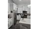 Modern kitchen featuring white cabinetry, stainless steel appliances, and a quartz countertop island at 12212 Holly Jane Ct, Orlando, FL 32824