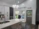 Updated kitchen with white cabinets, island, and view to backyard at 12212 Holly Jane Ct, Orlando, FL 32824