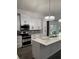 Beautiful kitchen with white cabinets, stainless steel appliances, quartz counters, and modern lighting at 12212 Holly Jane Ct, Orlando, FL 32824