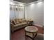 Cozy sitting area with comfortable sofa, patterned pillows, and warm hardwood flooring at 12212 Holly Jane Ct, Orlando, FL 32824
