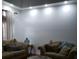 Cozy living room featuring neutral couches and a large blank wall at 12212 Holly Jane Ct, Orlando, FL 32824