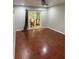 Empty room with hardwood floors and sliding glass doors with a dining table view at 12212 Holly Jane Ct, Orlando, FL 32824