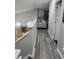Upstairs hallway with wood-look floors and access to bedrooms at 12212 Holly Jane Ct, Orlando, FL 32824