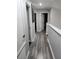 Upstairs hallway with wood-look floors and multiple doors at 12212 Holly Jane Ct, Orlando, FL 32824