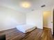 Spacious bedroom with wood-look floors and an adjacent bathroom at 361 Spring Leap Cir, Winter Garden, FL 34787