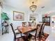 Elegant dining room with chandelier, large windows and hardwood table at 361 Spring Leap Cir, Winter Garden, FL 34787