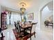 Elegant dining room with chandelier, large windows and hardwood table at 361 Spring Leap Cir, Winter Garden, FL 34787