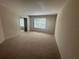 Cozy carpeted bedroom featuring ample natural light and closet at 10583 Regent Square Dr # 1206, Orlando, FL 32825