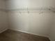 Walk-in closet with carpet and wire shelving at 10583 Regent Square Dr # 1206, Orlando, FL 32825