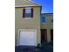 Two-story townhome with attached garage and burgundy accents at 10583 Regent Square Dr # 1206, Orlando, FL 32825