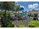 playground with play structures near a pond at 10583 Regent Square Dr # 1206, Orlando, FL 32825