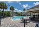 Community pool with lounge chairs and a covered seating area at 10583 Regent Square Dr # 1206, Orlando, FL 32825
