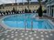 Community pool with a separate shallow area for children at 10583 Regent Square Dr # 1206, Orlando, FL 32825