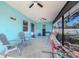 Covered patio with ceiling fan, comfortable seating, and hammock at 1188 Anne Elisa Cir, St Cloud, FL 34772
