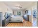 Spacious bedroom with a gray upholstered bed and ensuite access at 1188 Anne Elisa Cir, St Cloud, FL 34772
