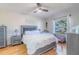 Well-lit bedroom with a gray upholstered bed and wood floors at 1188 Anne Elisa Cir, St Cloud, FL 34772