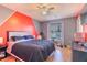 Spacious bedroom with a bed and a colorful accent wall at 1188 Anne Elisa Cir, St Cloud, FL 34772
