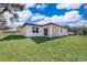 Covered patio, grassy backyard with surrounding trees at 13142 Sw 43Rd Avenue Rd, Ocala, FL 34473