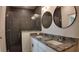 Bathroom with tiled shower, dual sink vanity with granite countertop, and modern fixtures at 1321 Congo Dr, Kissimmee, FL 34759