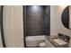 Modern bathroom with a granite countertop, a round mirror and tiled shower at 1321 Congo Dr, Kissimmee, FL 34759