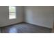 A minimalist bedroom features light grey floor tiles and a bright window at 1321 Congo Dr, Kissimmee, FL 34759