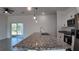 Open floor plan showcasing kitchen island with granite counters, stainless appliances, and sliding glass door to the yard at 1321 Congo Dr, Kissimmee, FL 34759