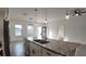 Kitchen island with granite countertop, stainless steel sink, and pendant lighting overlooking the living area at 1321 Congo Dr, Kissimmee, FL 34759