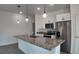 Modern kitchen features a large island with granite countertop and stainless steel appliances at 1321 Congo Dr, Kissimmee, FL 34759