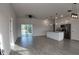 Open-concept living space with modern lighting and tile floors, seamlessly flowing into the kitchen at 1321 Congo Dr, Kissimmee, FL 34759
