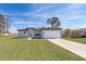New single-story home with attached garage and grassy yard at 15321 Sw 43Rd Avenue Rd, Ocala, FL 34473