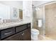 Bathroom with shower, toilet, vanity, and granite countertop at 1610 Lima Ave, Kissimmee, FL 34747