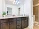 Bathroom with dark brown double vanity and granite countertop at 1610 Lima Ave, Kissimmee, FL 34747