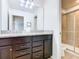 Bathroom with granite countertops, double sinks, and shower at 1610 Lima Ave, Kissimmee, FL 34747