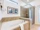 Bathroom with soaking tub, shower, and double vanity at 1610 Lima Ave, Kissimmee, FL 34747