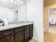 Clean bathroom with dark brown vanity and granite countertop at 1610 Lima Ave, Kissimmee, FL 34747