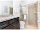 Bathroom with shower, toilet, vanity, and granite countertop at 1610 Lima Ave, Kissimmee, FL 34747
